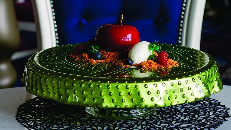 Royal Caribbean’s raspberry cremeux stuffed with coconut mousse, formed into an apple shape, and served with a brown butter crumble and yogurt ice cream from Wonderland.