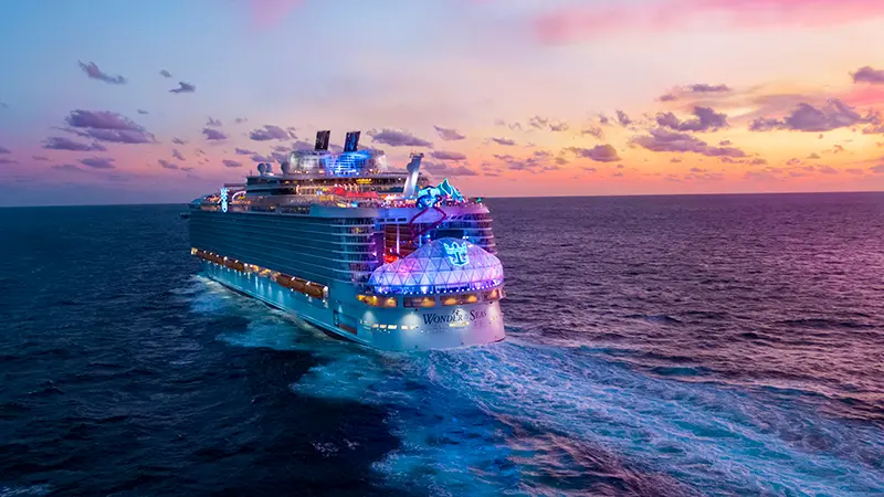 Royal Caribbean’s Wonder of the Seas sailing into the sunset.